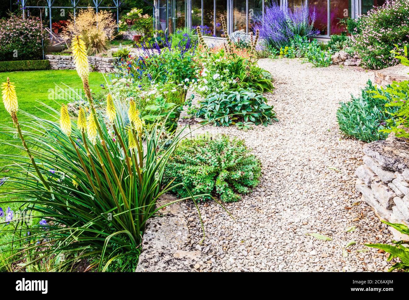 Terraced herbaceous borders in a sloping country garden. Stock Photo