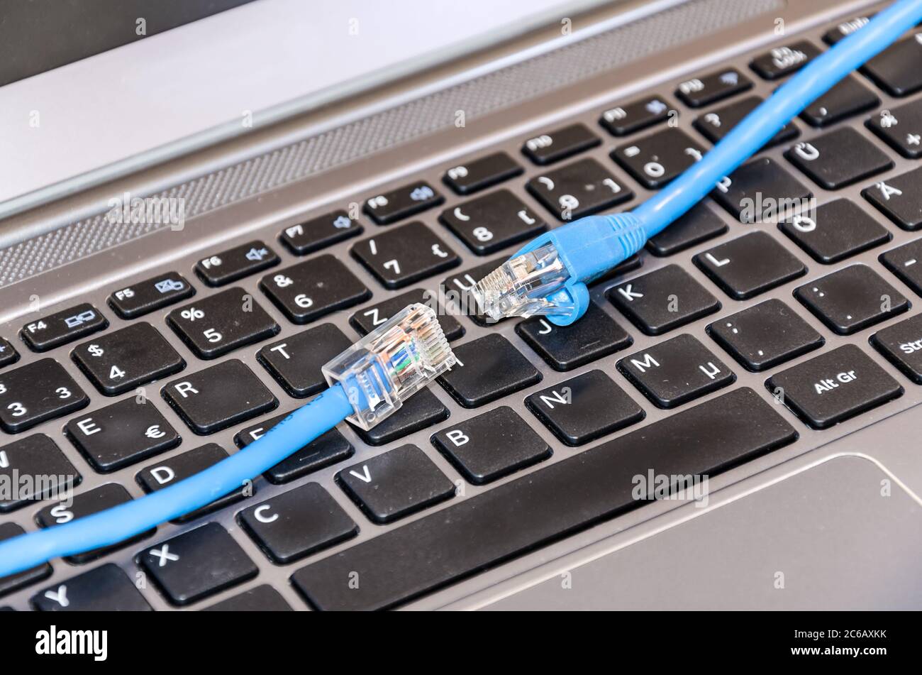 Two internet cable on computer keyboard Stock Photo - Alamy