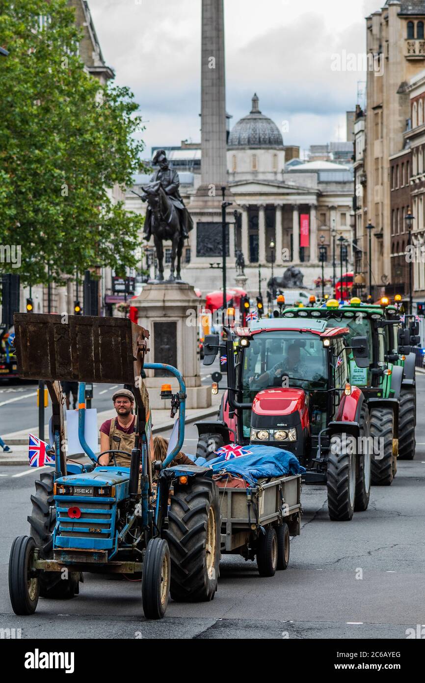 London, UK. 08th July, 2020. Heading down Whitehall - A slow convoy of tractors drives from New Covent Garden Market to Westminster to object to a possible trade deal with the USA that does not respect British food standards. Save British Farming and Extinction Rebellion protest on the day Rishi Sunak delivers a summer economic update to Parliament. Credit: Guy Bell/Alamy Live News Stock Photo