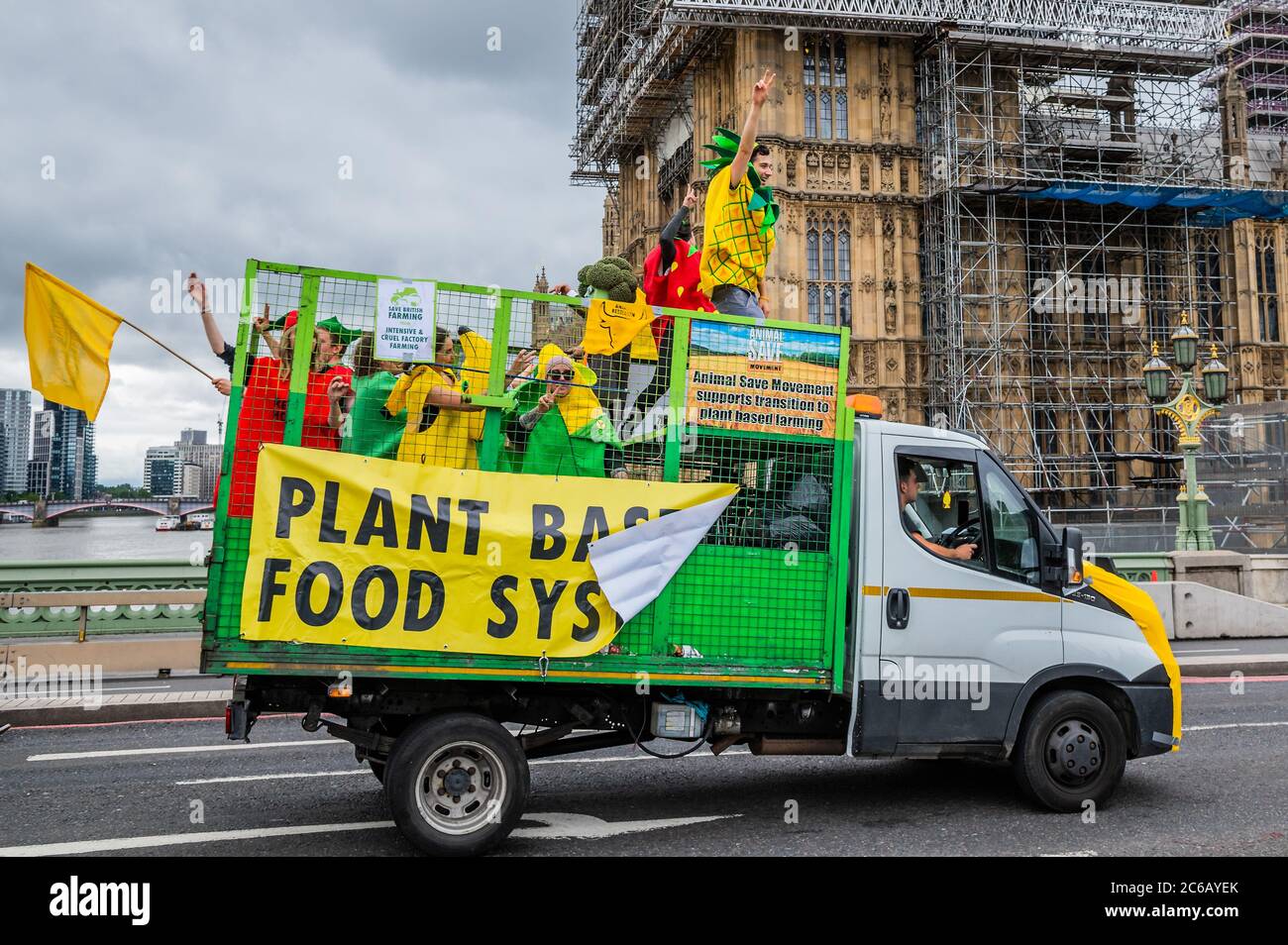London, UK. 08th July, 2020. XR activists in fruit and veg costumes call for a plant based food system - A slow convoy of tractors drives from New Covent Garden Market to Westminster to object to a possible trade deal with the USA that does not respect British food standards. Save British Farming and Extinction Rebellion protest on the day Rishi Sunak delivers a summer economic update to Parliament. Credit: Guy Bell/Alamy Live News Stock Photo