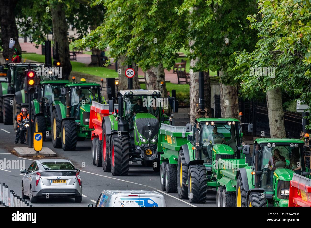 London, UK. 08th July, 2020. Driving along the Embankment - A slow convoy of tractors drives from New Covent Garden Market to Westminster to object to a possible trade deal with the USA that does not respect British food standards. Save British Farming and Extinction Rebellion protest on the day Rishi Sunak delivers a summer economic update to Parliament. Credit: Guy Bell/Alamy Live News Stock Photo