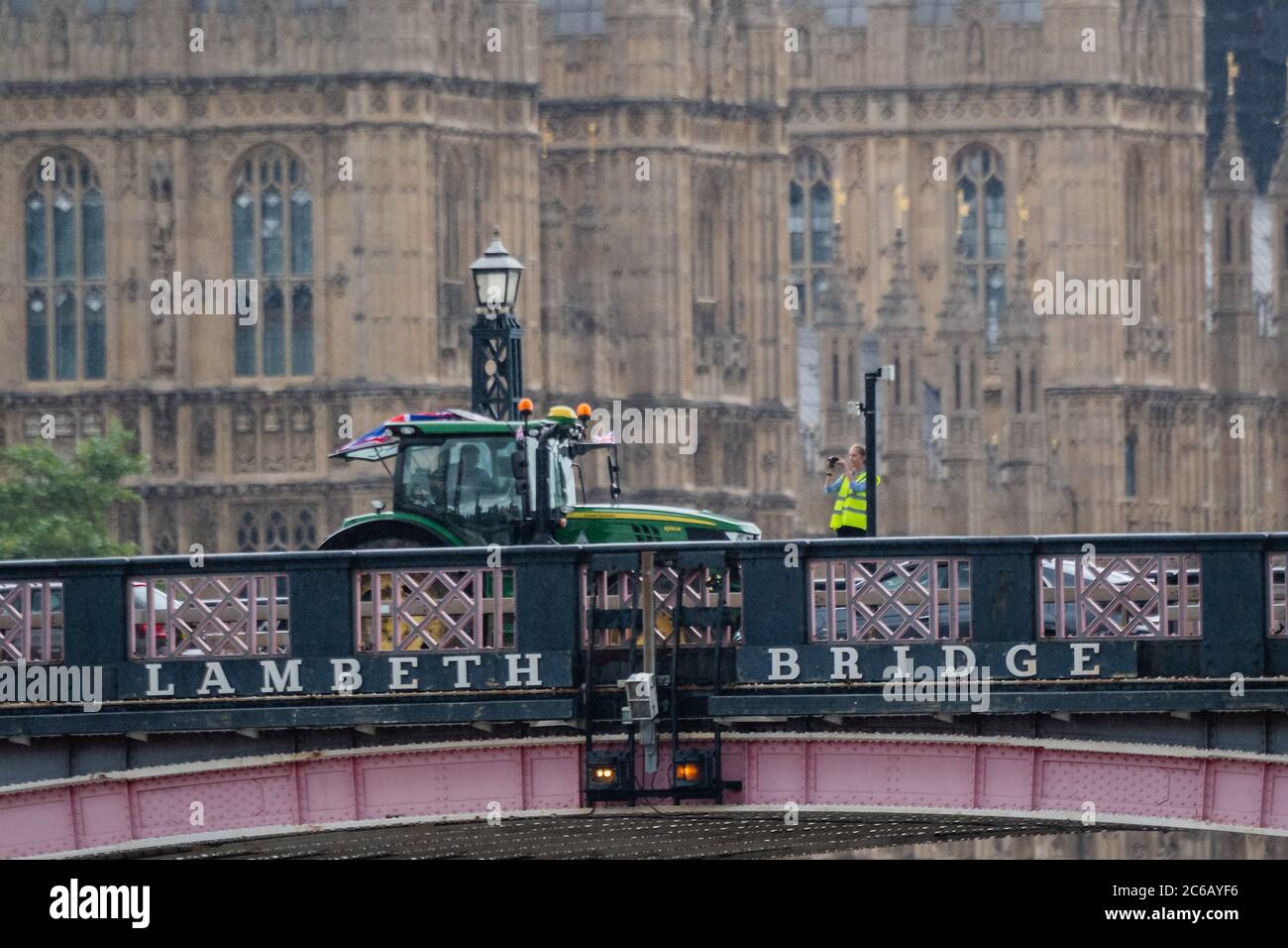 London, UK. 08th July, 2020. Passing over Lambeth Bridge - A slow convoy of tractors drives from New Covent Garden Market to Westminster to object to a possible trade deal with the USA that does not respect British food standards. Save British Farming and Extinction Rebellion protest on the day Rishi Sunak delivers a summer economic update to Parliament. Credit: Guy Bell/Alamy Live News Stock Photo