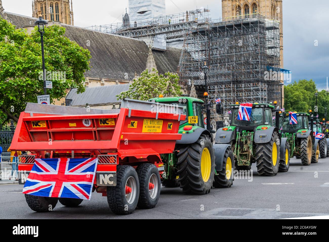 London, UK. 08th July, 2020. A slow convoy of tractors drives from New Covent Garden Market to Westminster to object to a possible trade deal with the USA that does not respect British food standards. Save British Farming and Extinction Rebellion protest on the day Rishi Sunak delivers a summer economic update to Parliament. Credit: Guy Bell/Alamy Live News Stock Photo