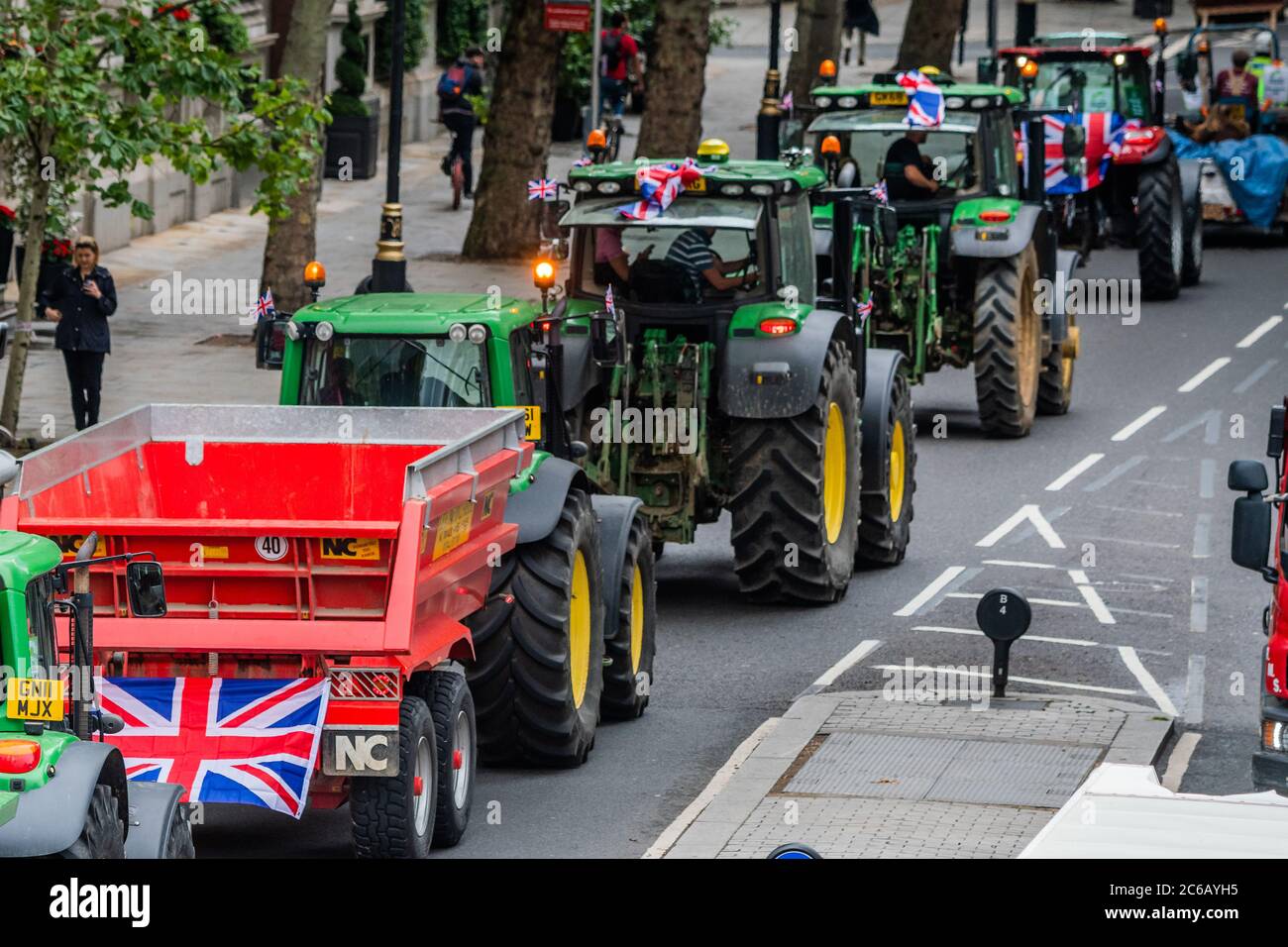 London, UK. 08th July, 2020. Driving along the Embankment - A slow convoy of tractors drives from New Covent Garden Market to Westminster to object to a possible trade deal with the USA that does not respect British food standards. Save British Farming and Extinction Rebellion protest on the day Rishi Sunak delivers a summer economic update to Parliament. Credit: Guy Bell/Alamy Live News Stock Photo