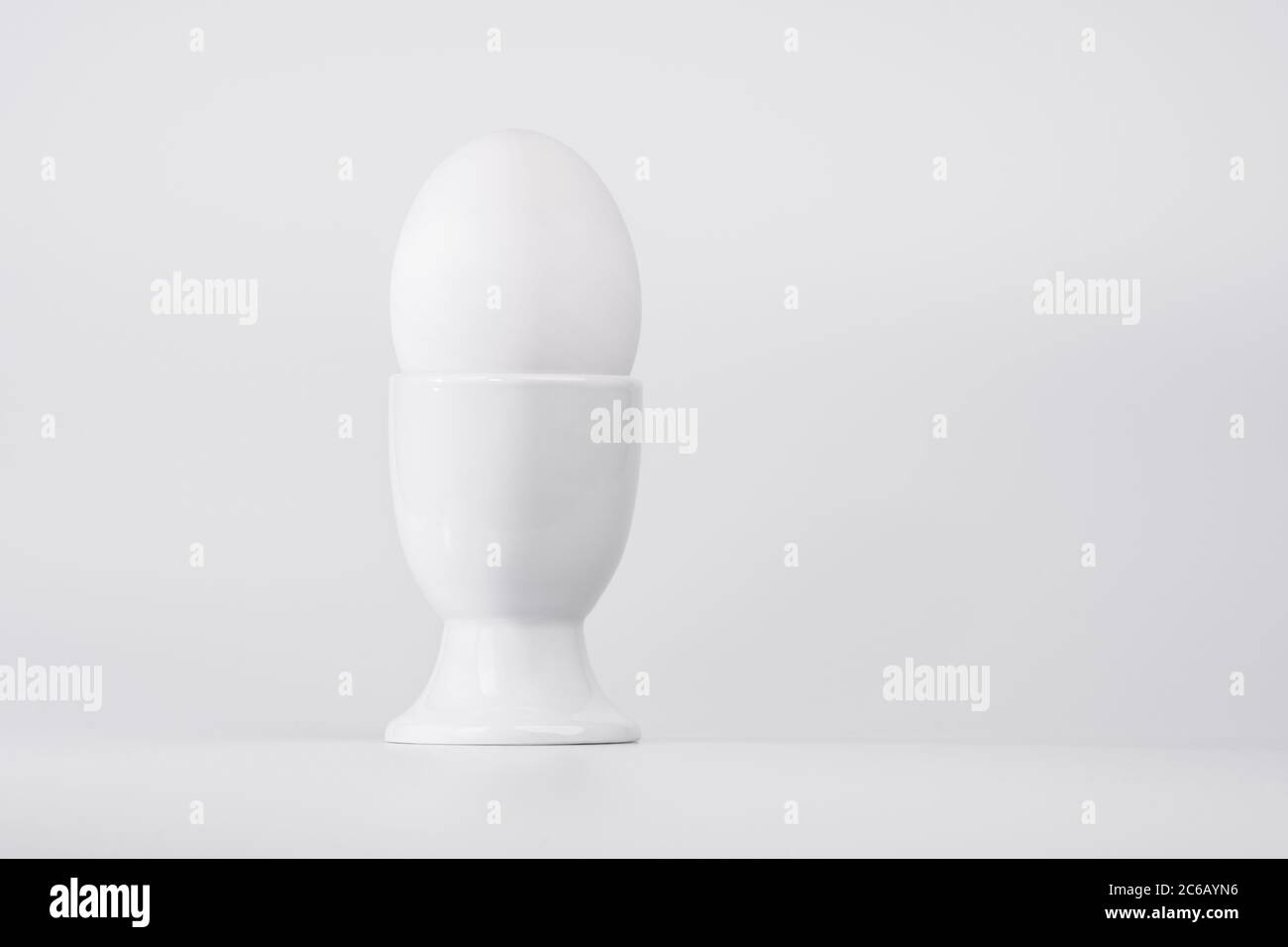 White egg in white egg cup on a white background Stock Photo