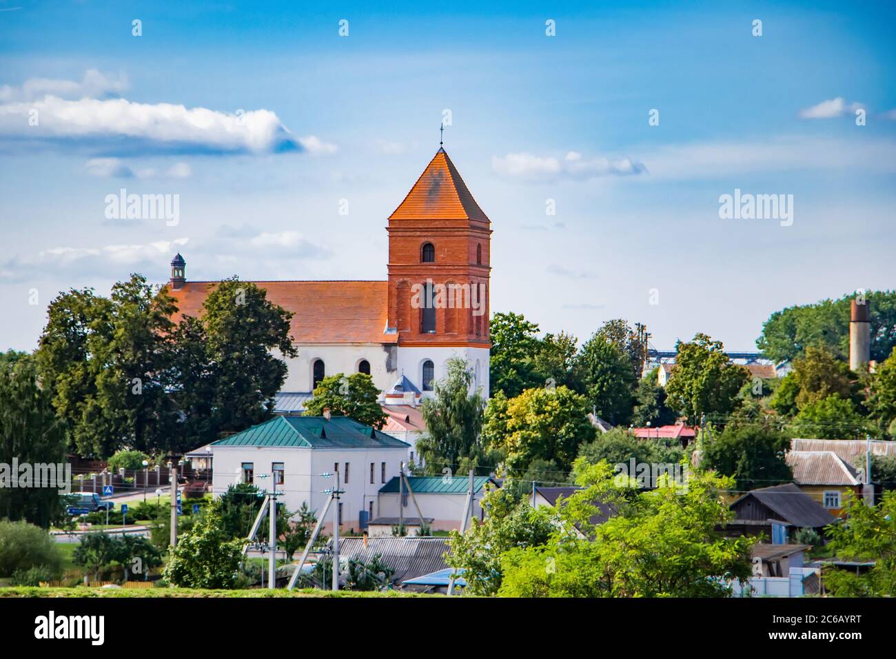 Old medieval building against the blue sky. Ancient architecture. House with red roof tiles. Stock Photo