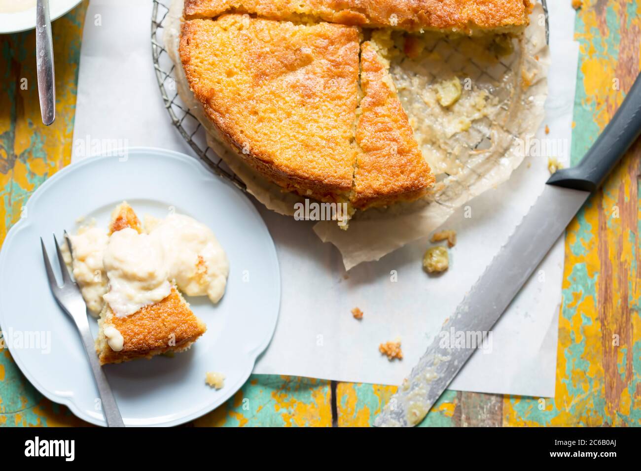 Sticky gooseberry saffron cake with vanilla custard Stock Photo Alamy