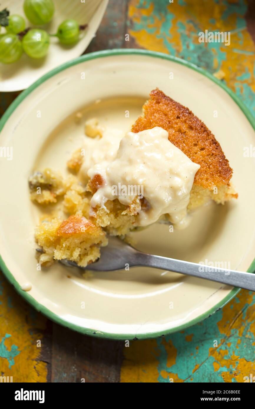 Sticky gooseberry saffron cake with vanilla custard Stock Photo Alamy