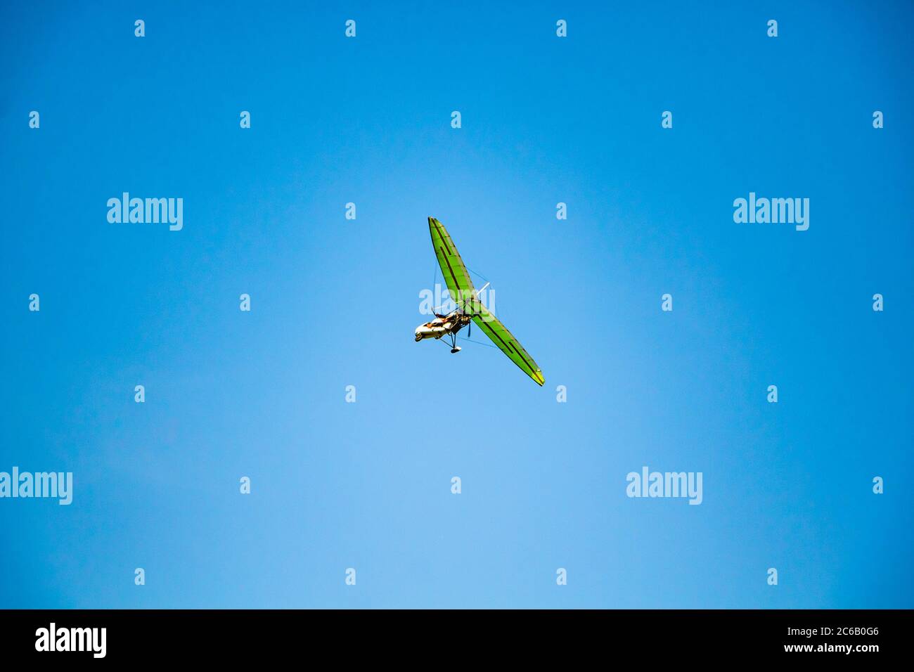 Hang glider in the blue sky. Extreme dangerous sport, air flights. Stock Photo