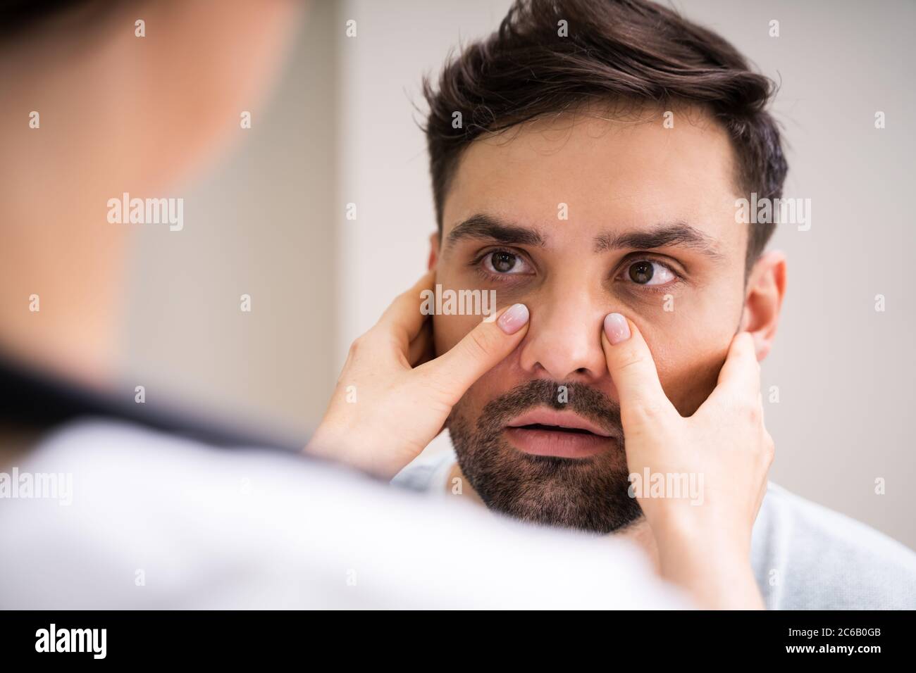 Physician Doctor Doing Sinusitis Examination For Sinus Inflammation
