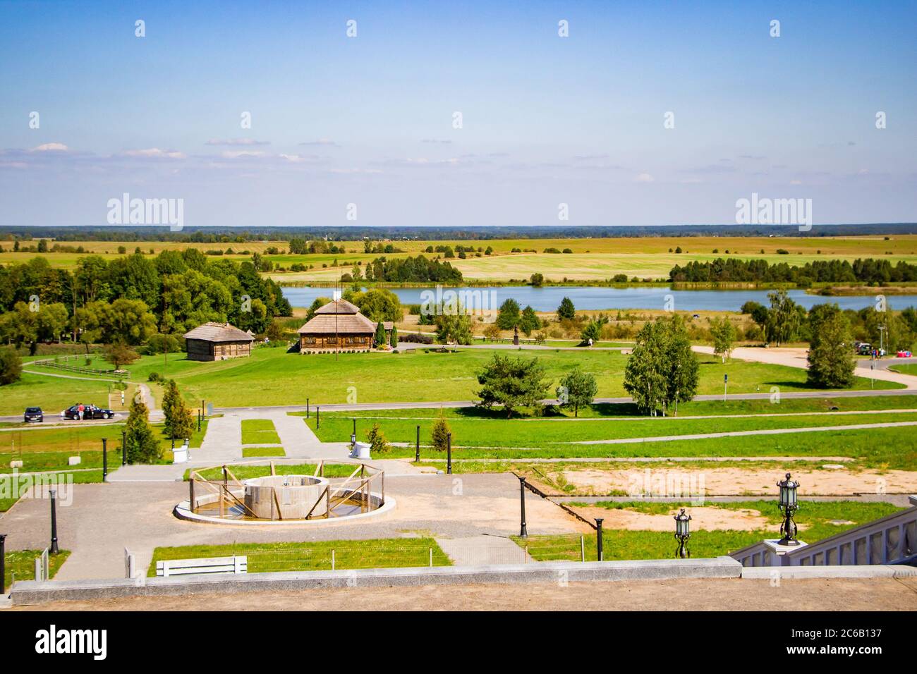 A beautiful place for walking. Park with walking paths on the lake. Summer sunny landscape. Stock Photo