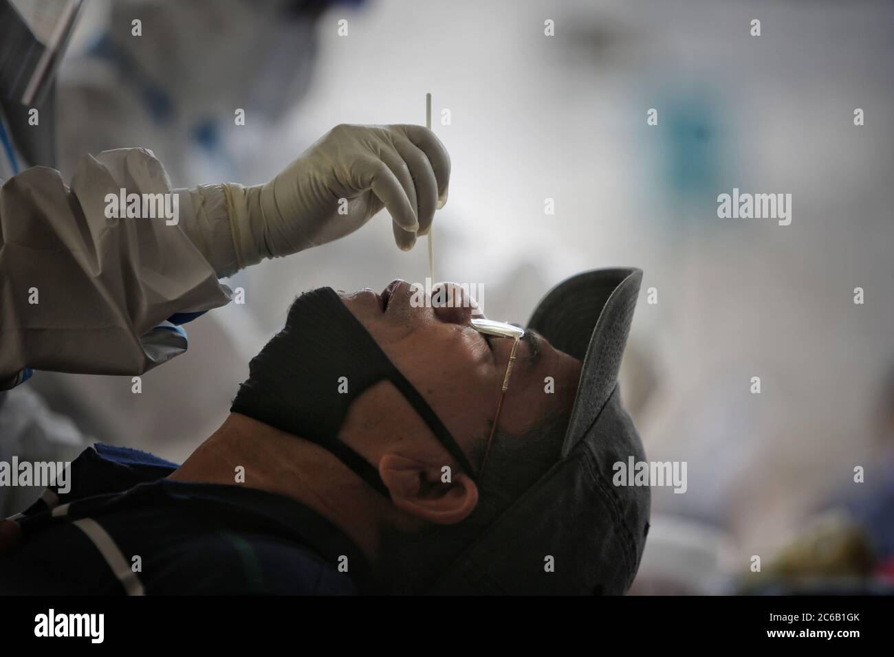 Kathmandu. 8th July, 2020. A man takes a polymerase chain reaction (PCR