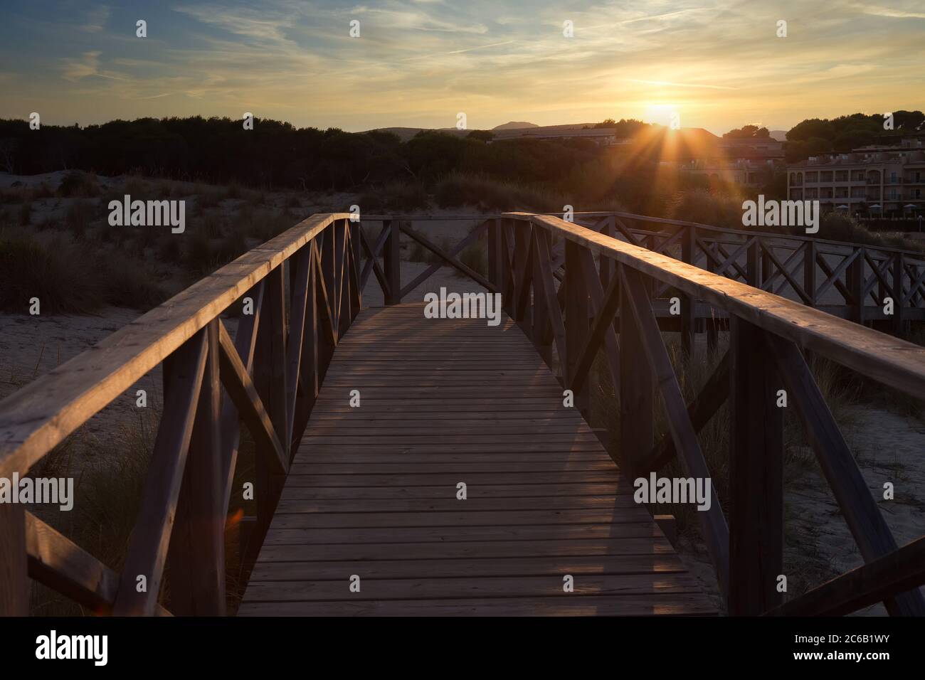 Europe Spain Mallorca - Dunes of Cala Mesquida at sunset, Wooden pier by backlight, Stock Photo