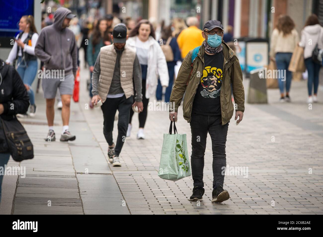 Glasgow, Scotland, UK. 8th July, 2020. Pictured: People wearing cafe masks and face coverings whilst out shopping in Glasgow city centre. Nicola Sturgeon announced on the 2nd July that wearing a face covering in shops will become mandatory on the10th July. Face coverings are already mandatory when taking public transport in a bid to slow down the spread of coronavirus. Credit: Colin Fisher/Alamy Live News Stock Photo