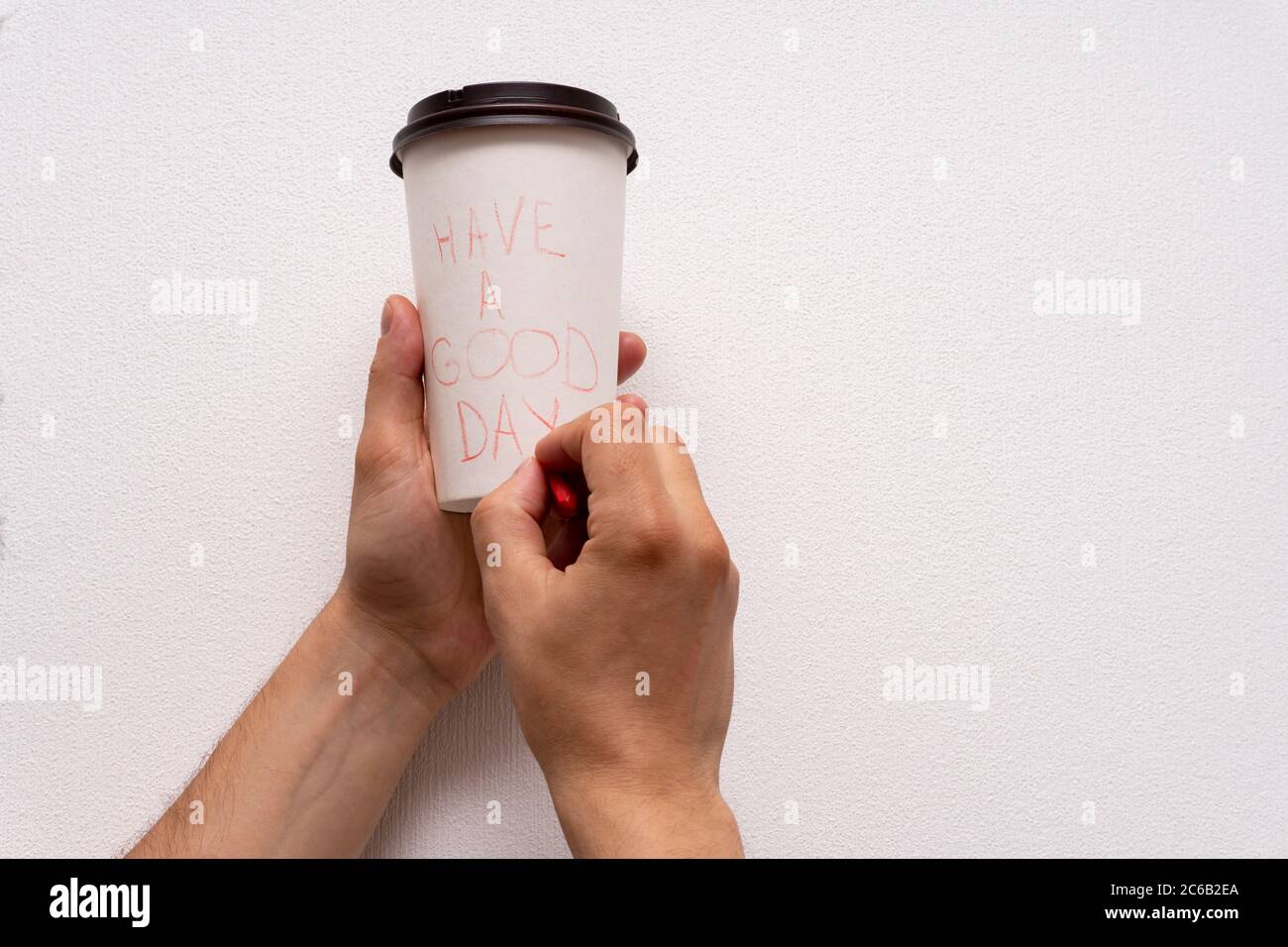 Caucasian hands writing message with have a good time at paper takeaway coffee Stock Photo
