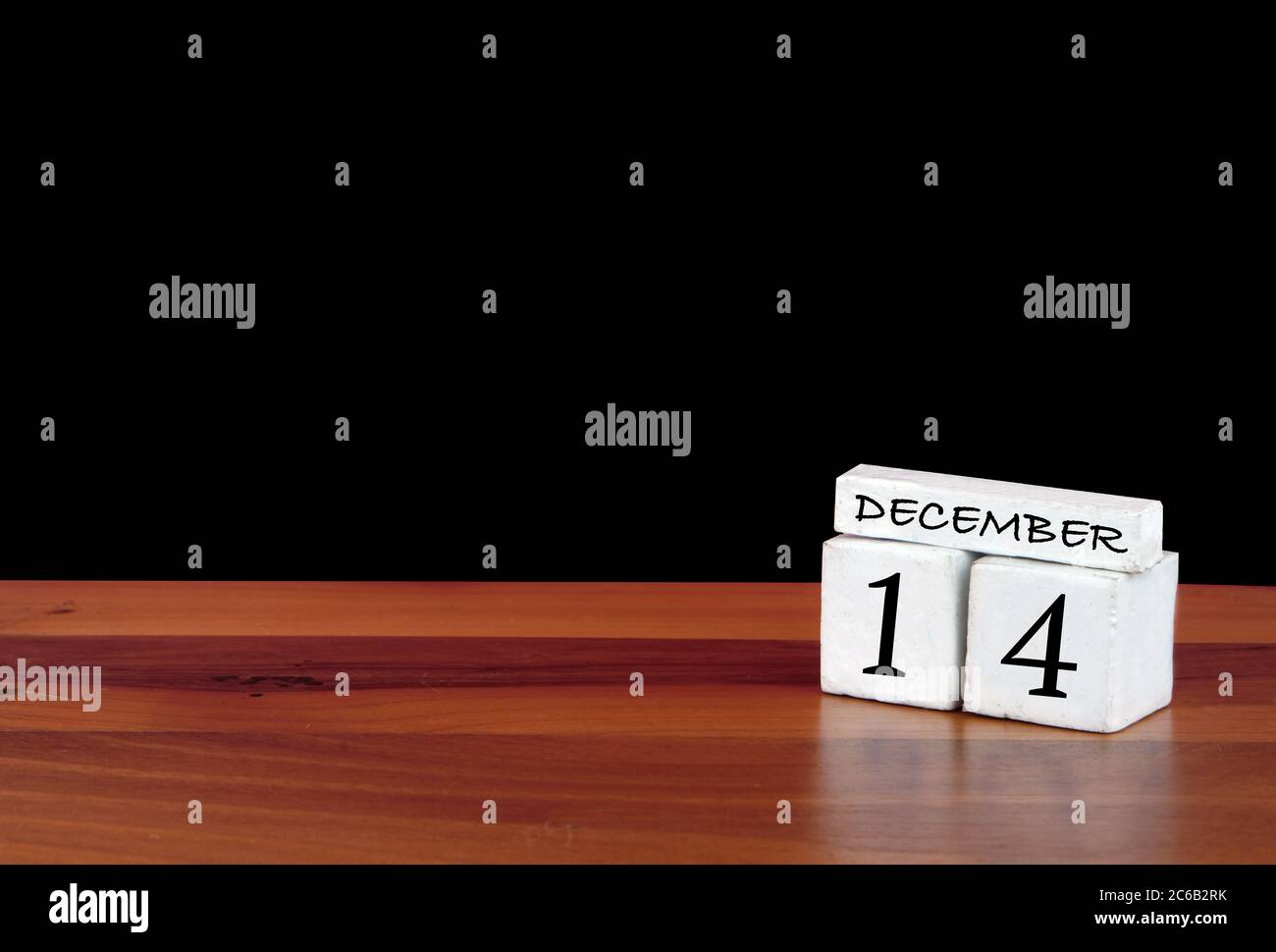 14 December calendar month. 14 days of the month. Reflected calendar on wooden floor with black background Stock Photo