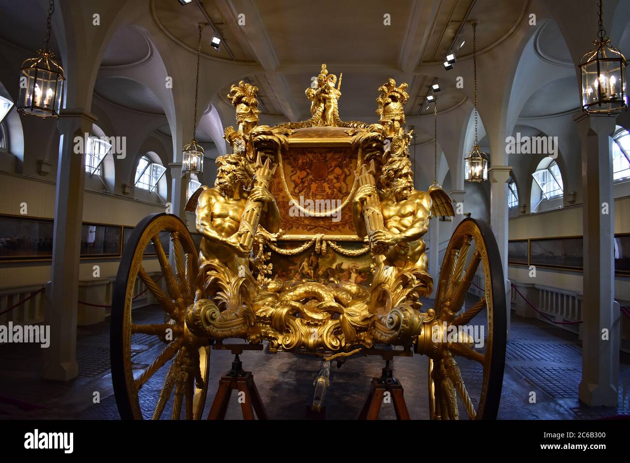 The back end of the Gold State Coach on display in the Royal Mews at  Buckingham Place. An ornate gilded enclosed eight horse drawn carriage  Stock Photo - Alamy