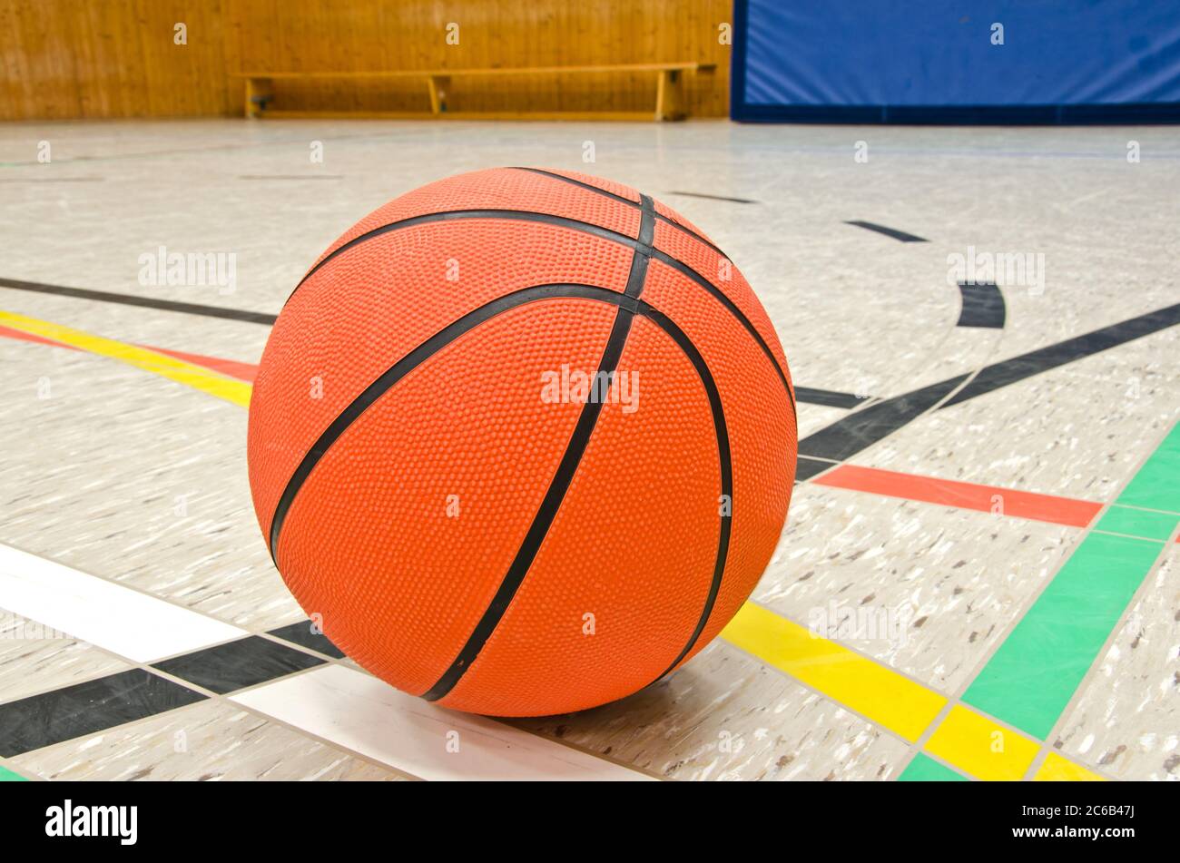 Closeup of basketball on the floor in sports hall Stock Photo