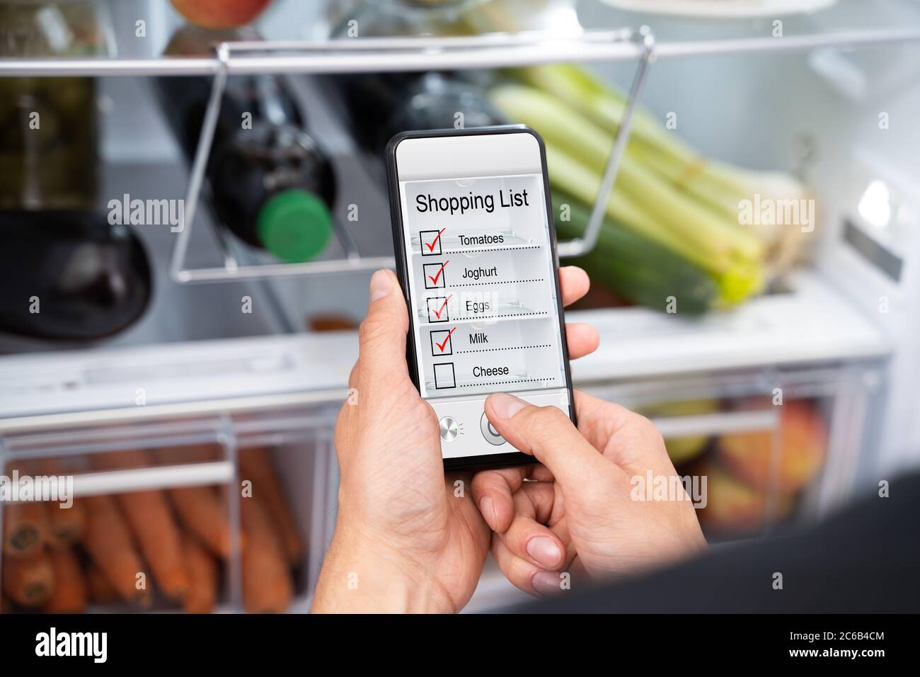 Consumer Grocery Shopping List App And Fridge Stock Photo