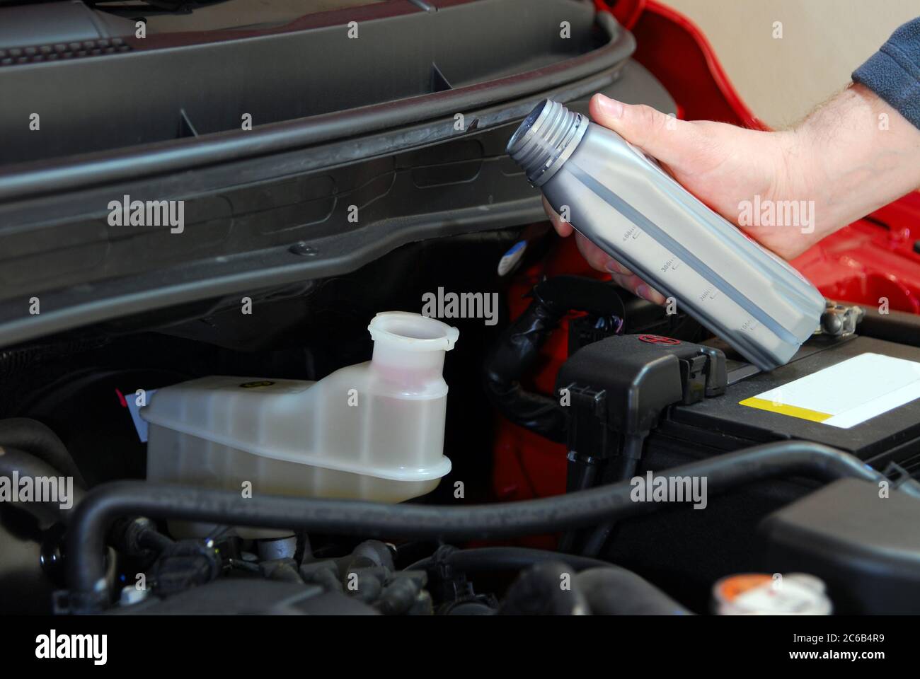 Adding brake fluid to a car Stock Photo Alamy