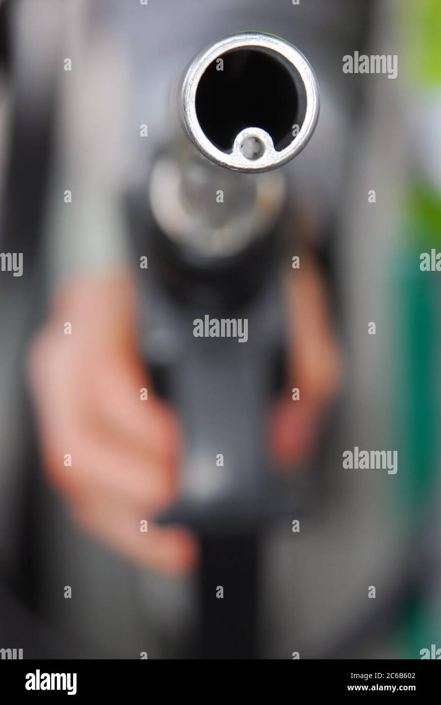Gas Pump Nozzle, look askance at the hand holding the gas nozzle Stock