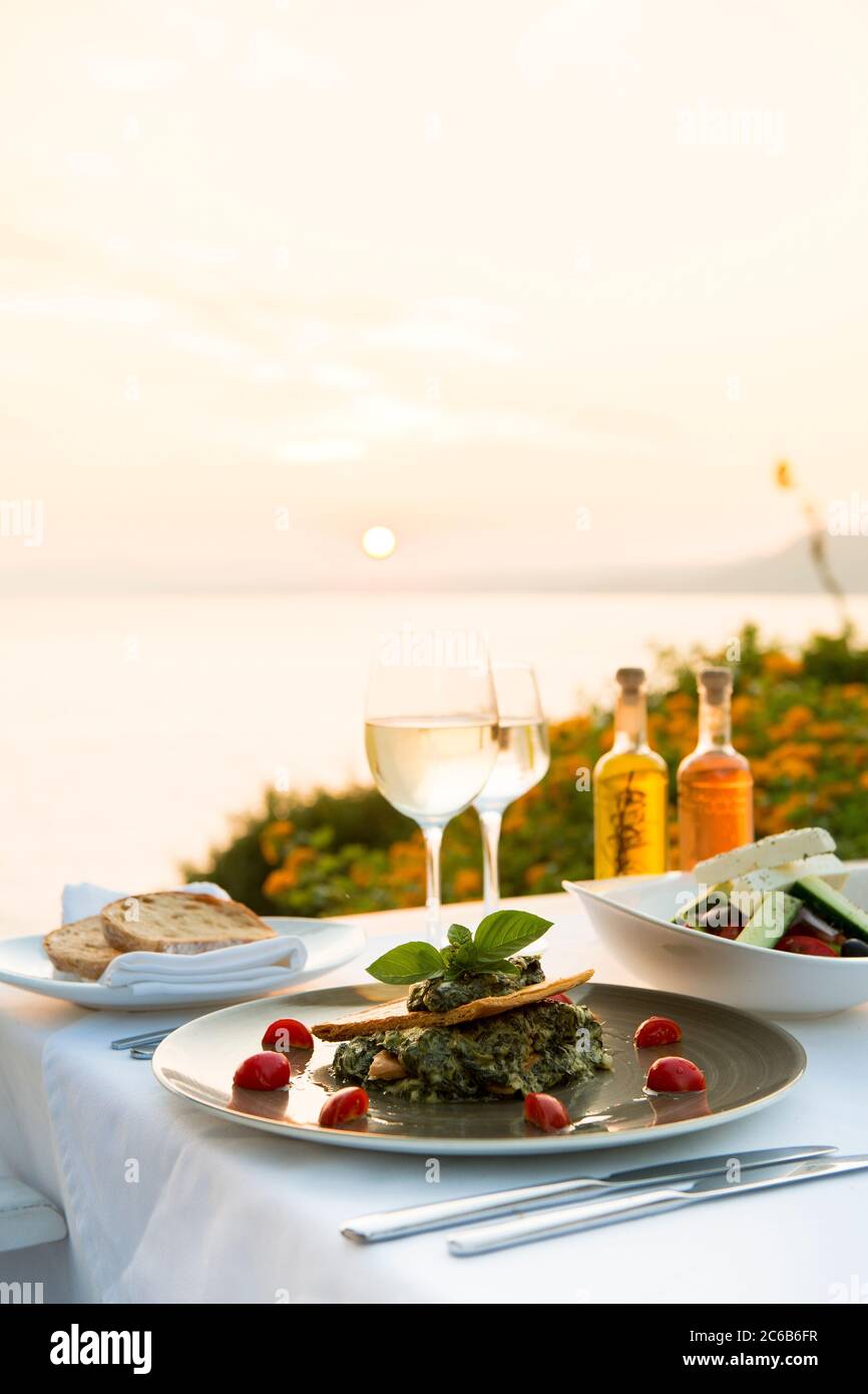Food at a restaurant with a view over Pefkos Beach beach at sunset, Pefkos, Rhodes, Dodecanese, Greek Islands, Greece, Europe Stock Photo
