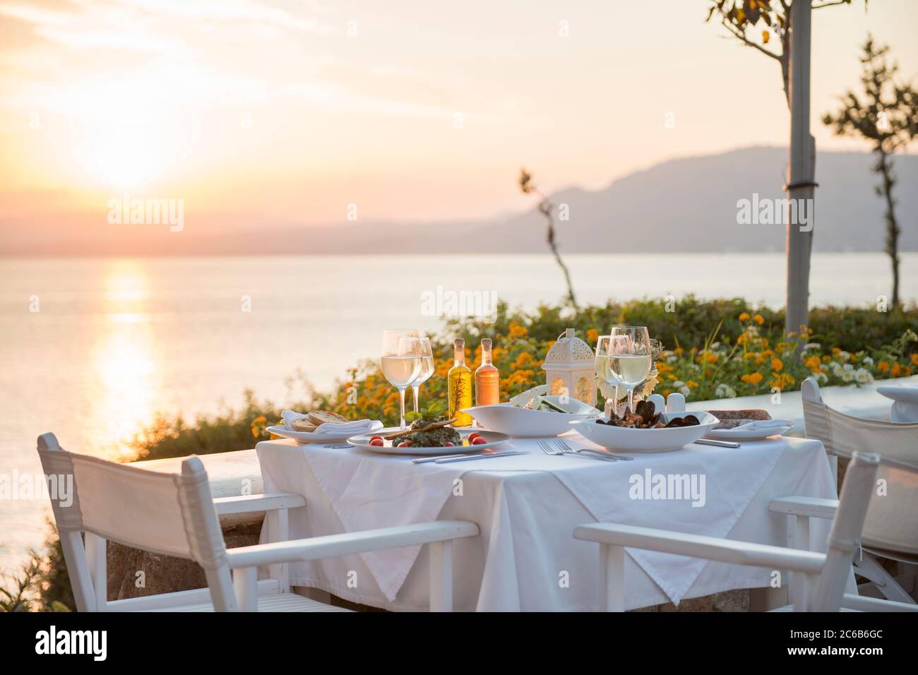 Food at a restaurant with a view over Pefkos Beach beach at sunset, Pefkos, Rhodes, Dodecanese, Greek Islands, Greece, Europe Stock Photo