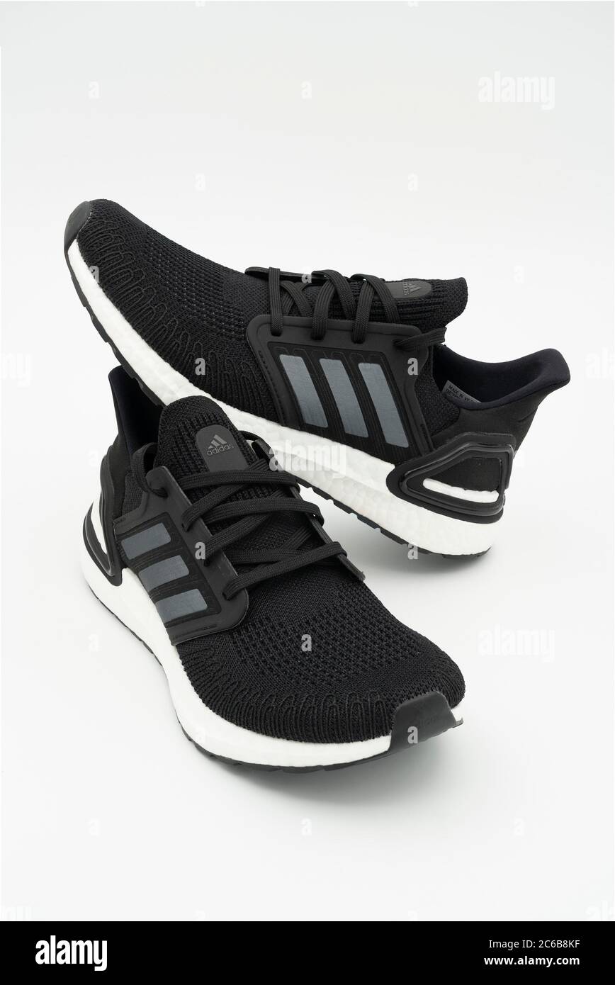 Pair of black Adidas Ultraboost 20 running shoes cut out isolated on ...