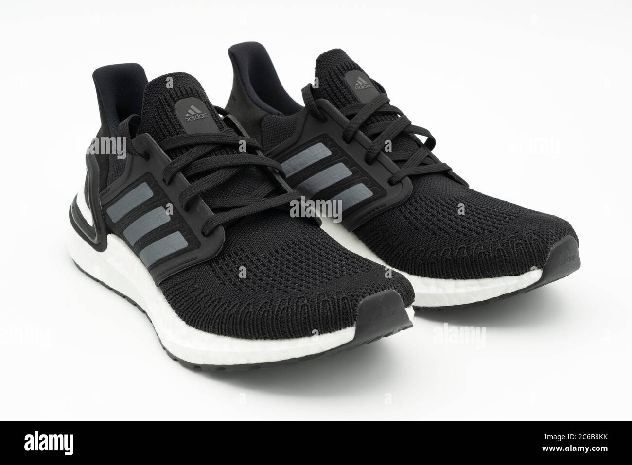 Pair of black Adidas Ultraboost 20 running shoes cut out isolated on white  background Stock Photo - Alamy