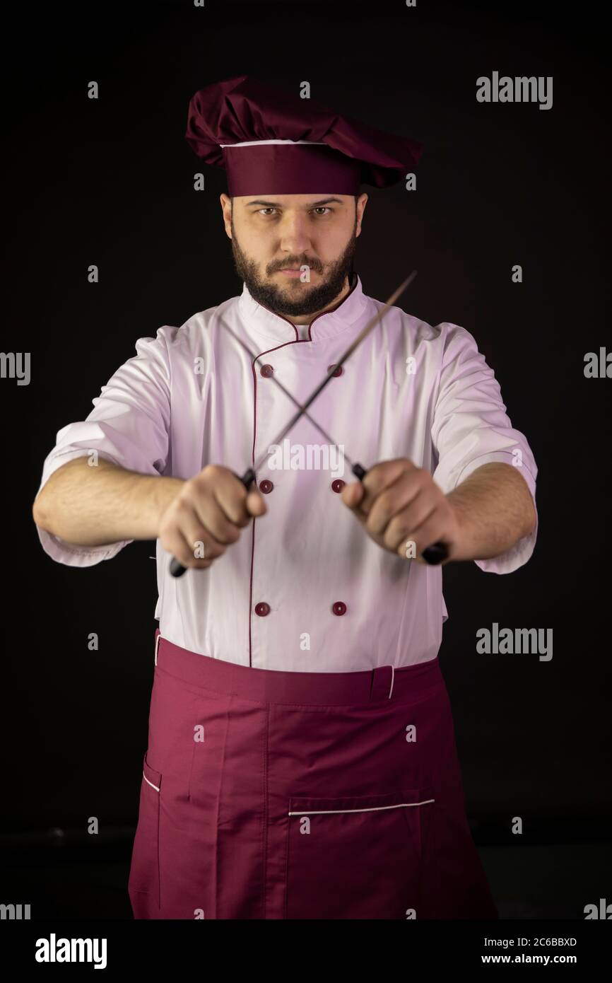 Bearded Male Chef Cook Wearing Violet Apron And Cap Holds Crossed Sharp 