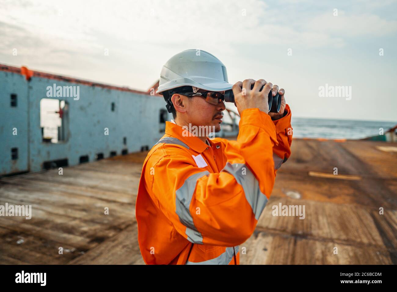 Filipino deck Officer on deck of vessel or ship , wearing PPE personal