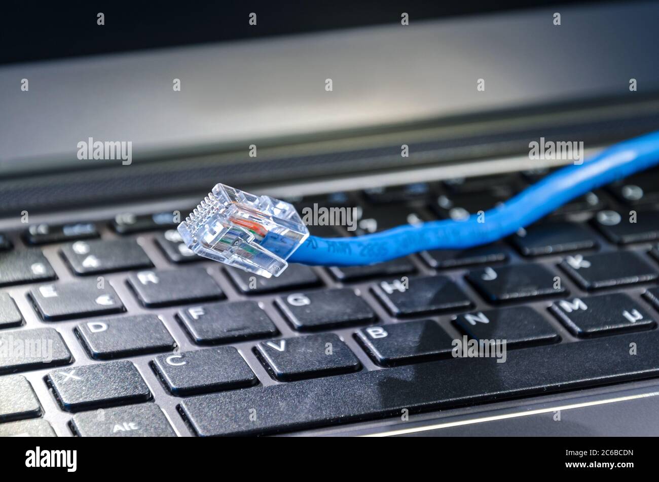 Internet cable on computer keyboard Stock Photo