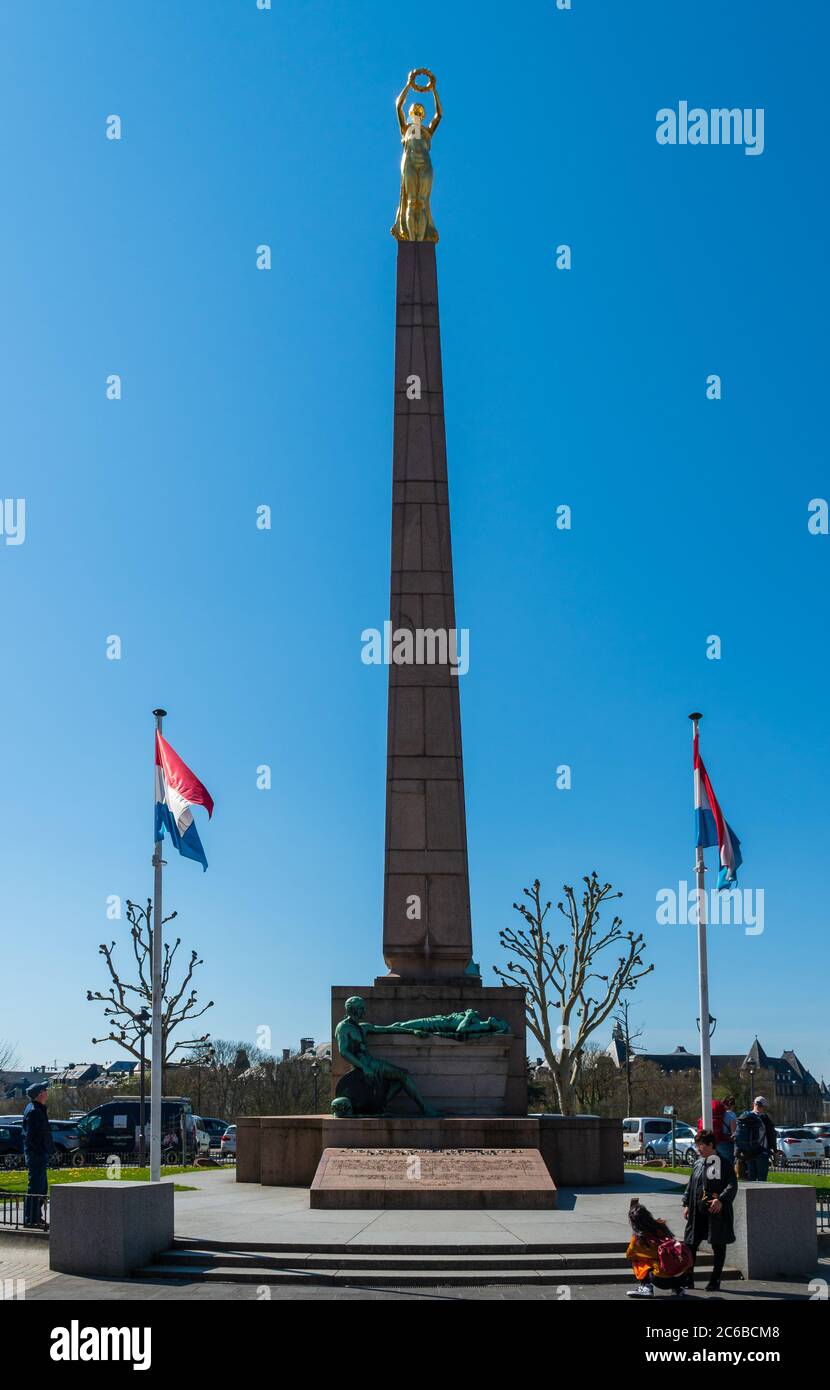 LUXEMBOURG CITY, LUXEMBOURG - APRIL 18, 2019: Tourists marveling at the Monument of Remembrance ('Golden Lady'), sculpted by Claus Cito. Stock Photo