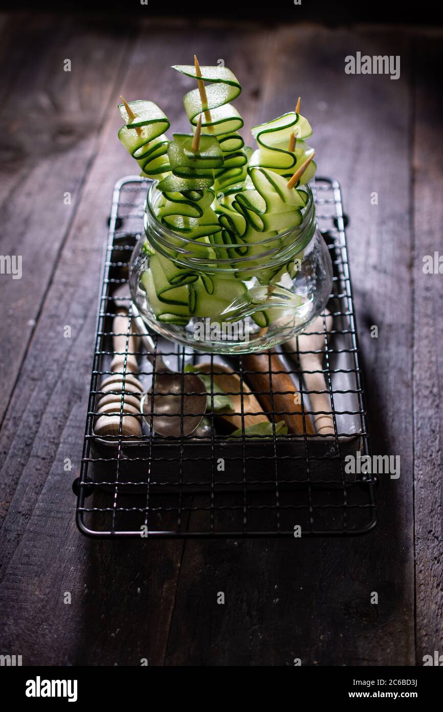 Cucumber salad.A crunchy snack.Healthy food and drink.Skewers in a jar.Country style. Stock Photo