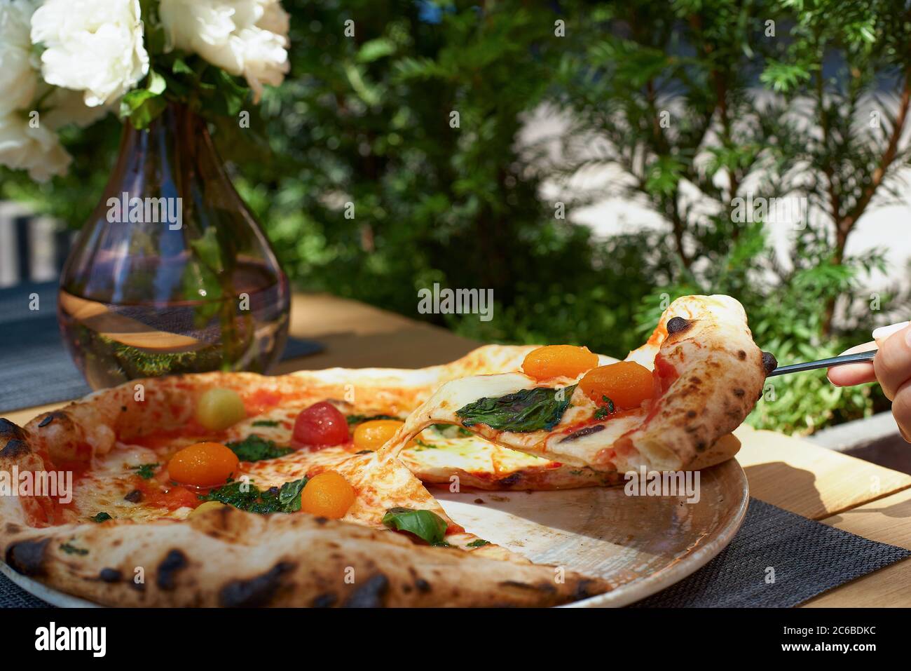 Italian pizza with anchovies, olives and tomatoes, on the table