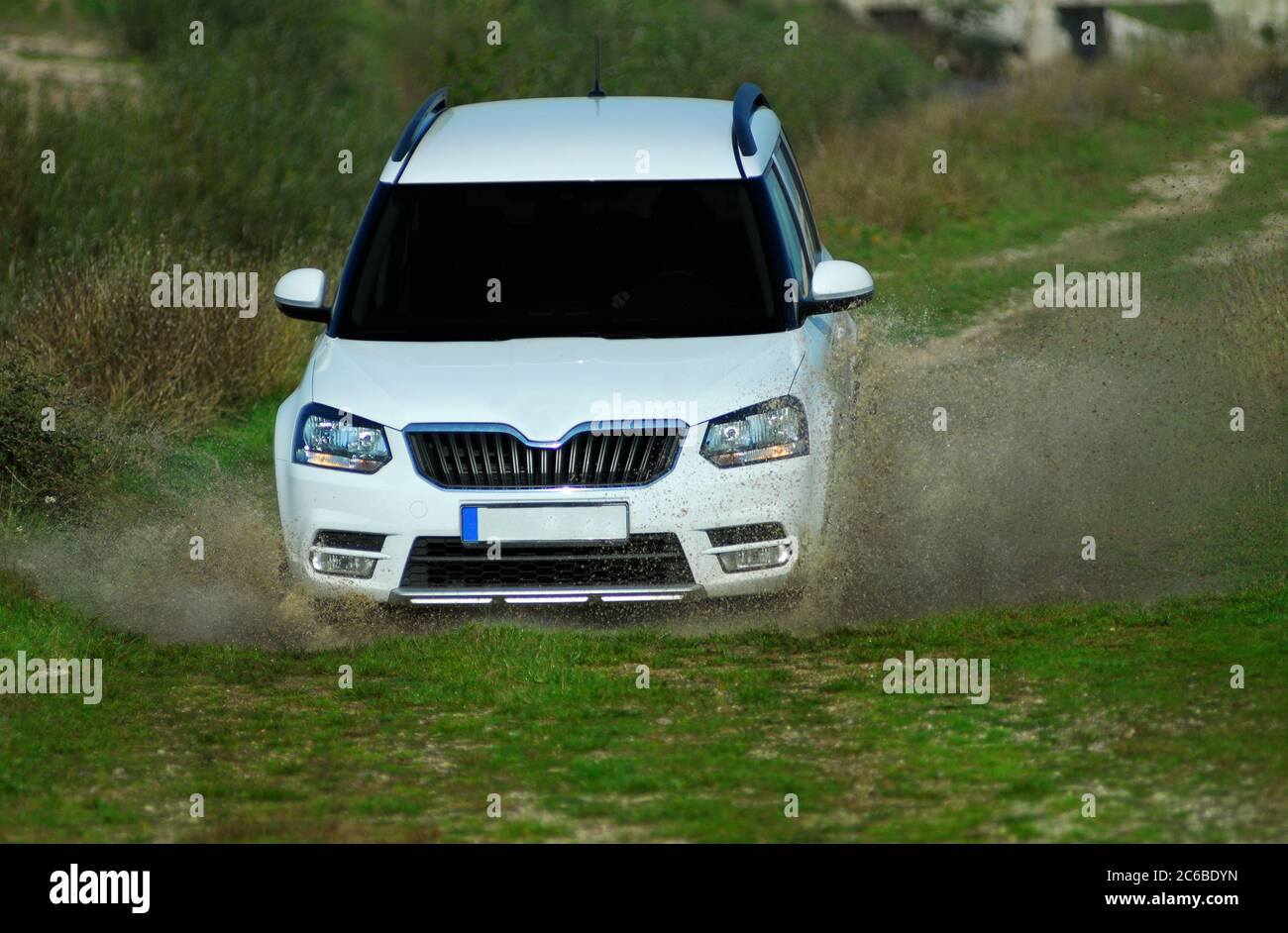 suv drives through water, suv drives through flooded road Stock Photo