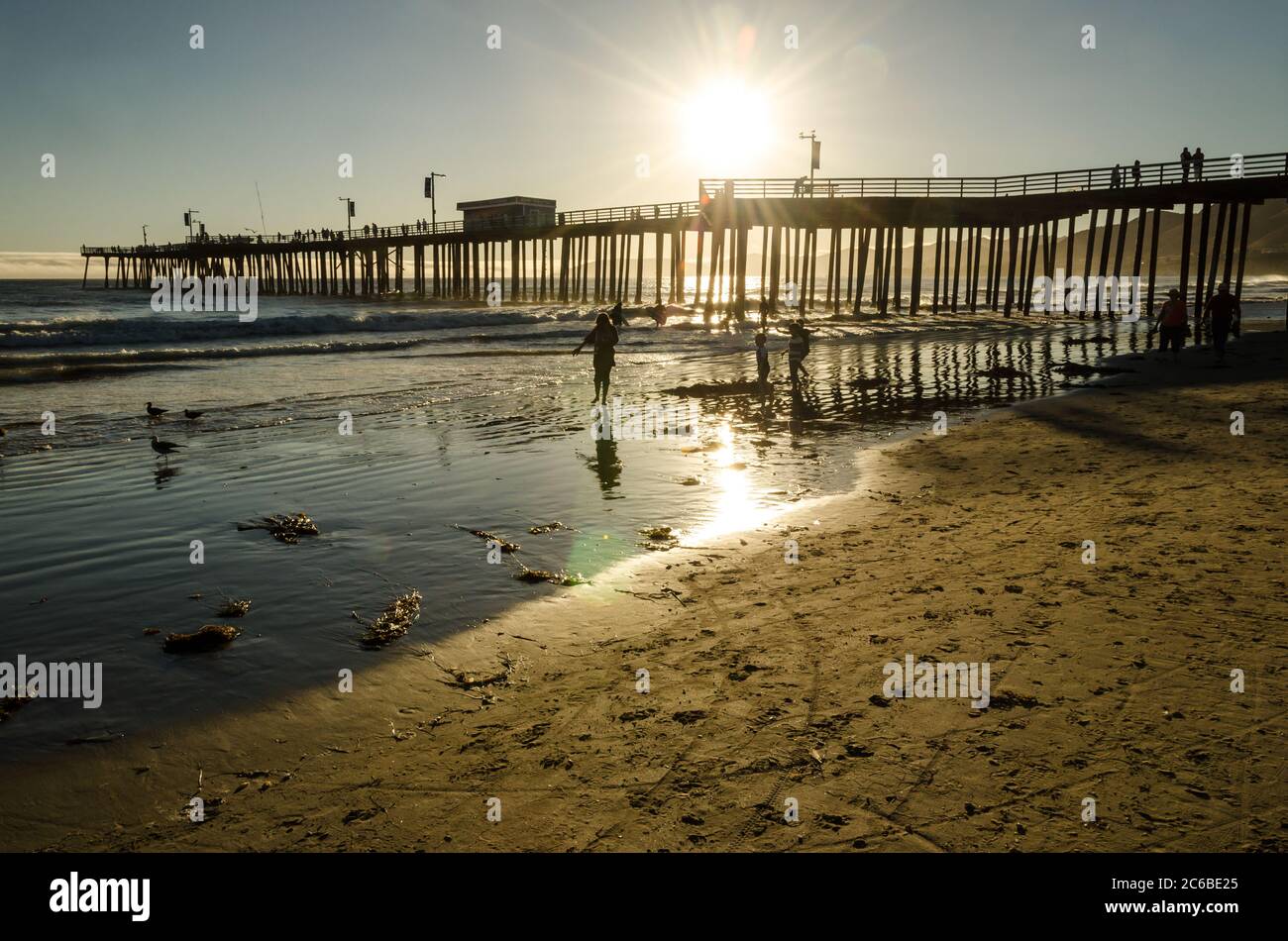 Pier at the beach in California during sunset Stock Photo