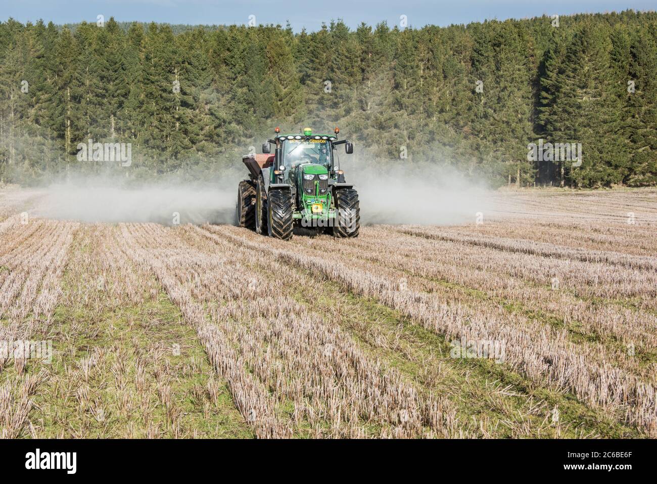 Rock dust and lime spreading on fields before cultivation. The spreading of crushed basalt could remove vast amounts of CO2 from the air Stock Photo