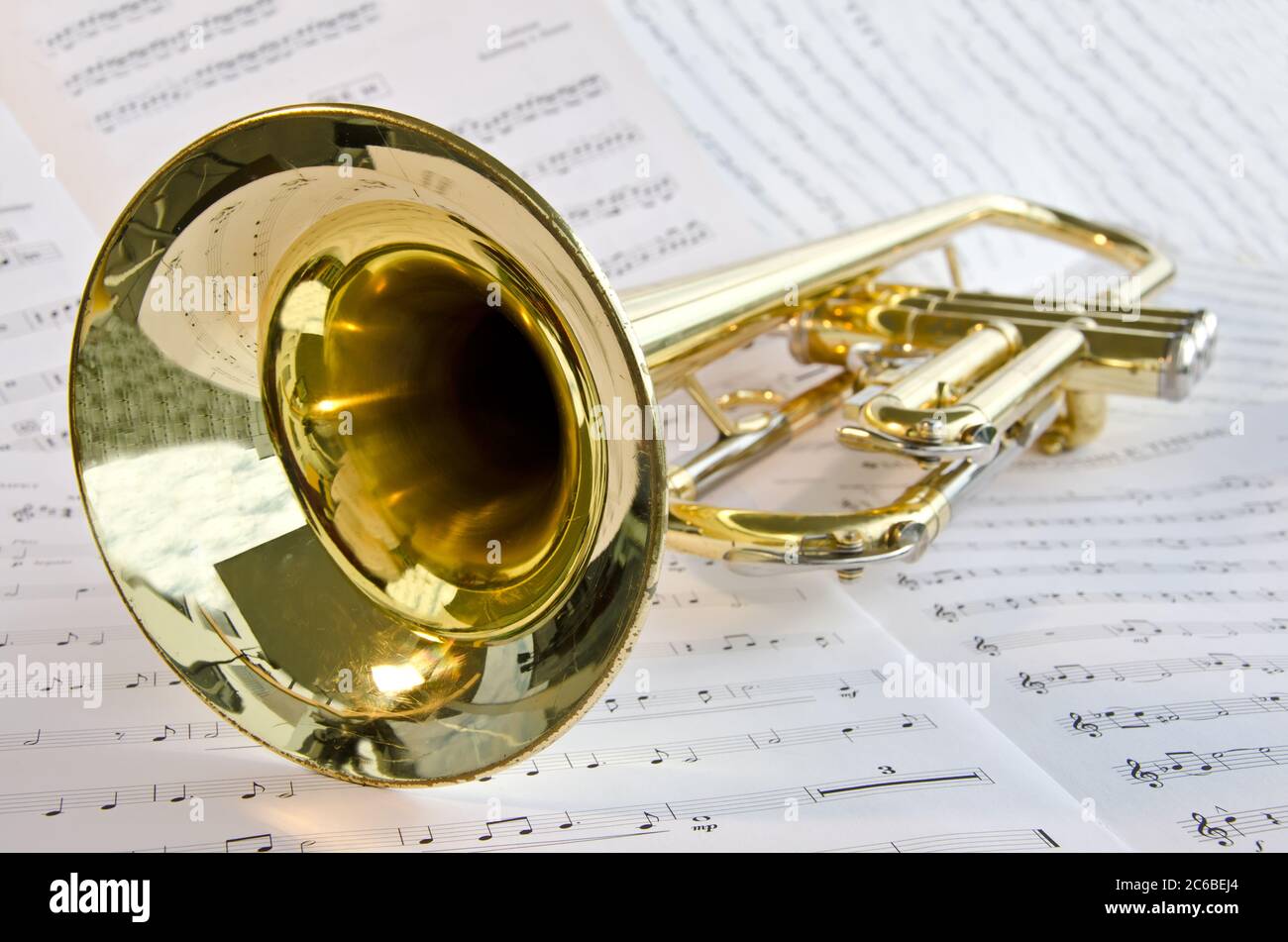 Closeup of trumpet lying on sheet music Stock Photo
