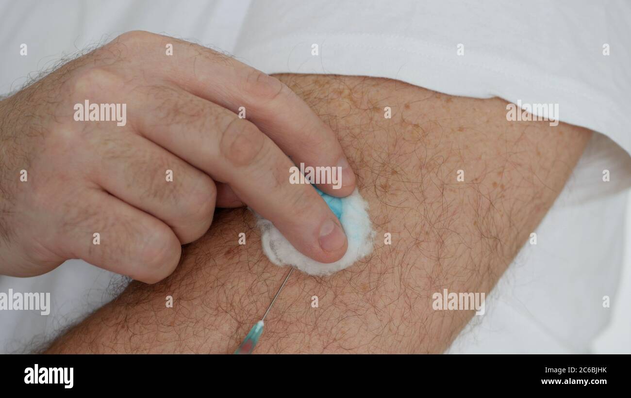 Person Making in His Arm a Vaccine Against Flu, Grippe or Cold, Treatment for the Pandemic of Covid-19 Stock Photo