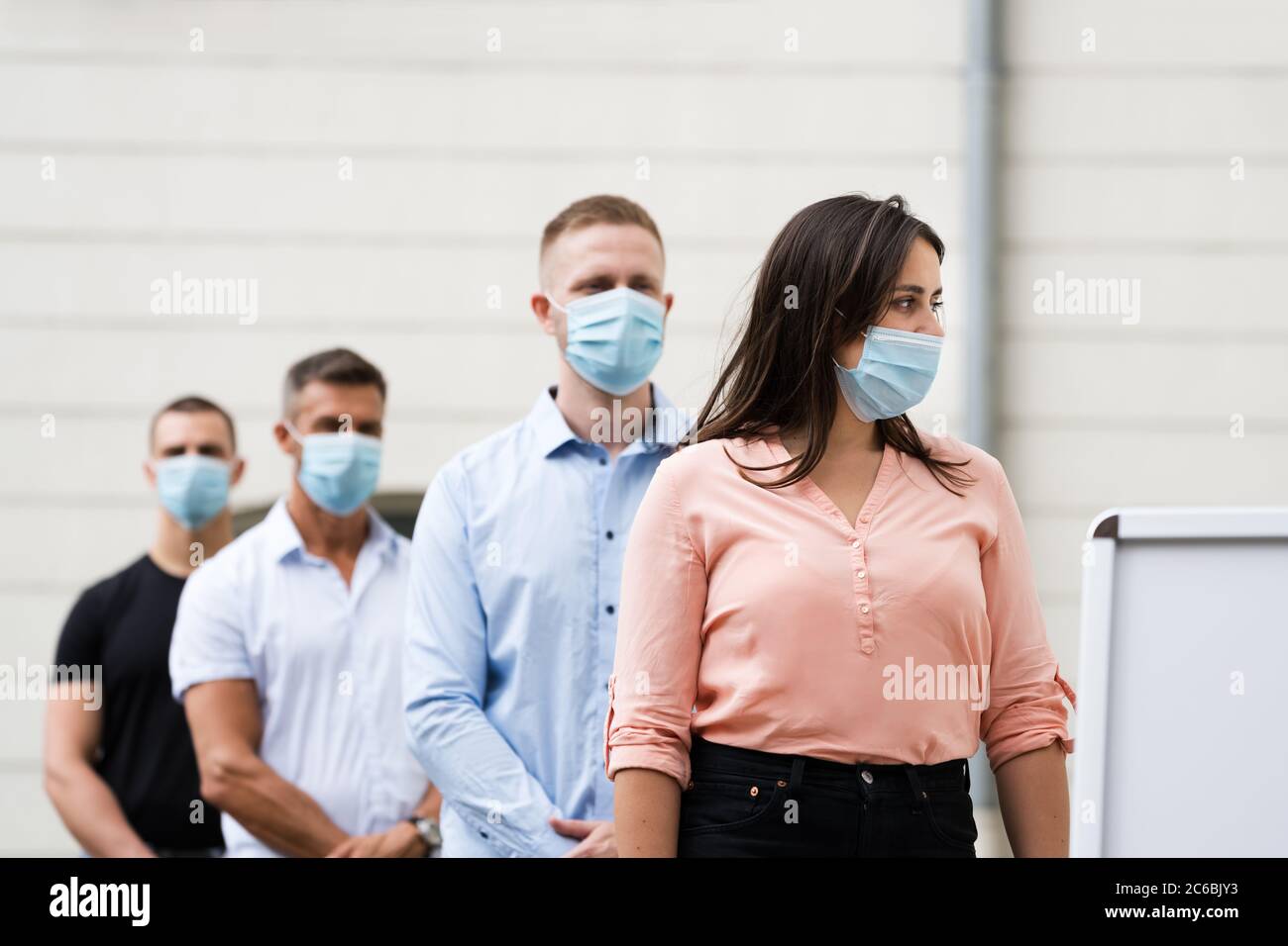 Job Center Line Of Jobless Unemployed Recruitment Seekers With Face Masks Stock Photo