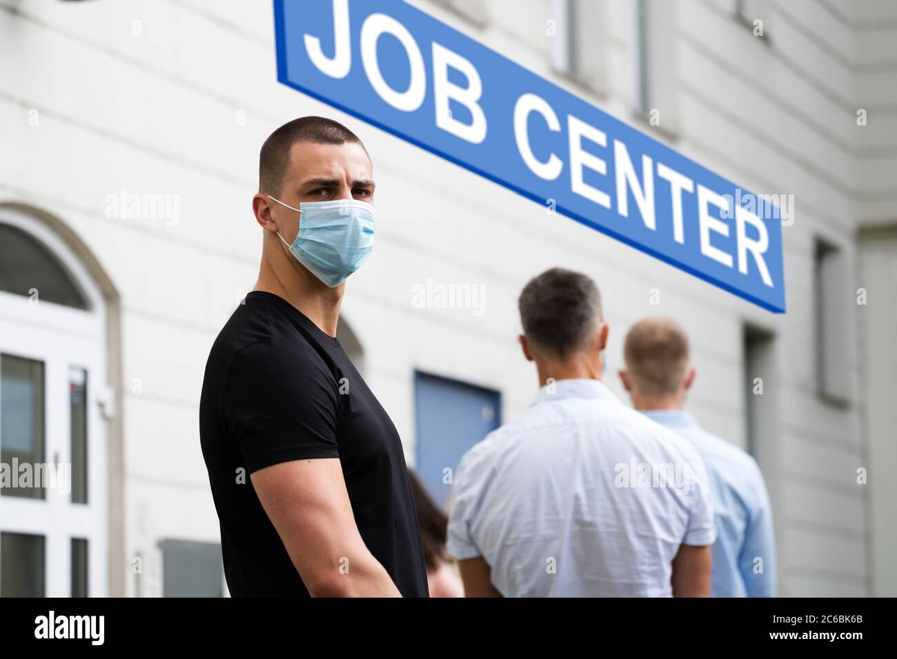 Job Center Line Of Jobless Unemployed Recruitment Seekers With Face Masks Stock Photo