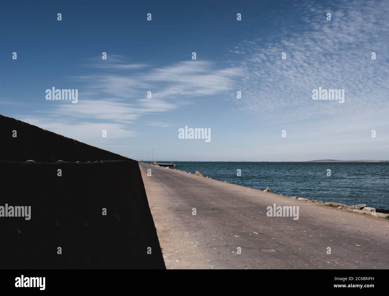 Pier leading small village hi-res stock photography and images - Alamy