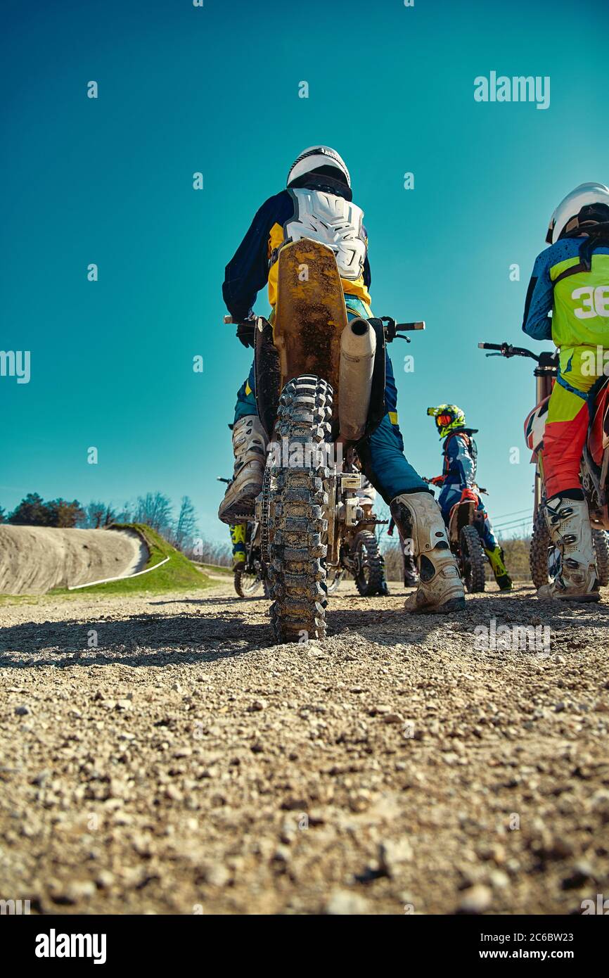 Close-up of biker sitting on motorcycle in starting point before the ...