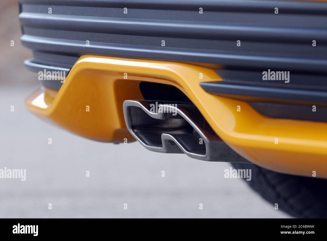 Exhaust pipe system. Tailpipe sports car. Close up of tailpipe on