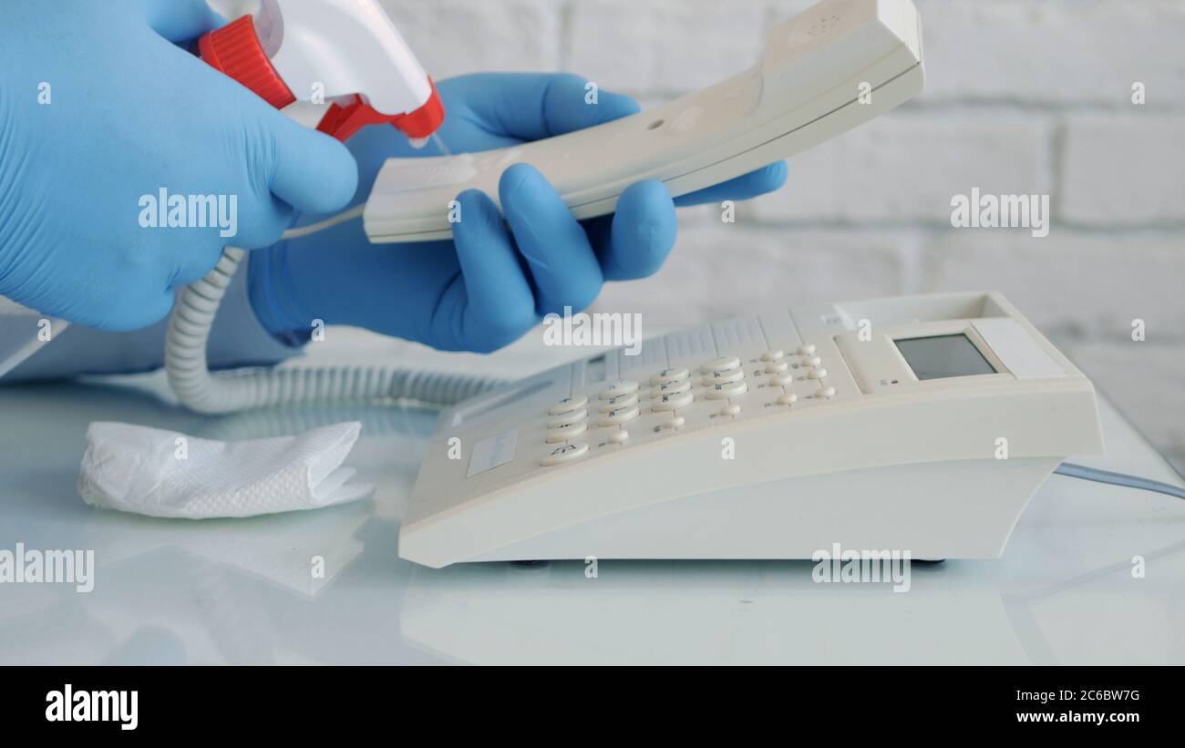 Man Wearing Protection Gloves in Hands Cleaning and Disinfecting a