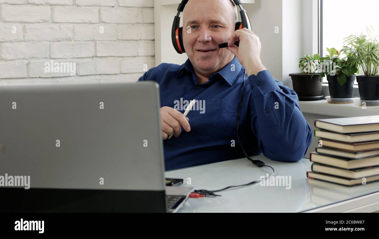 Man Working Remote from Home Using Laptop Connection Stock Photo