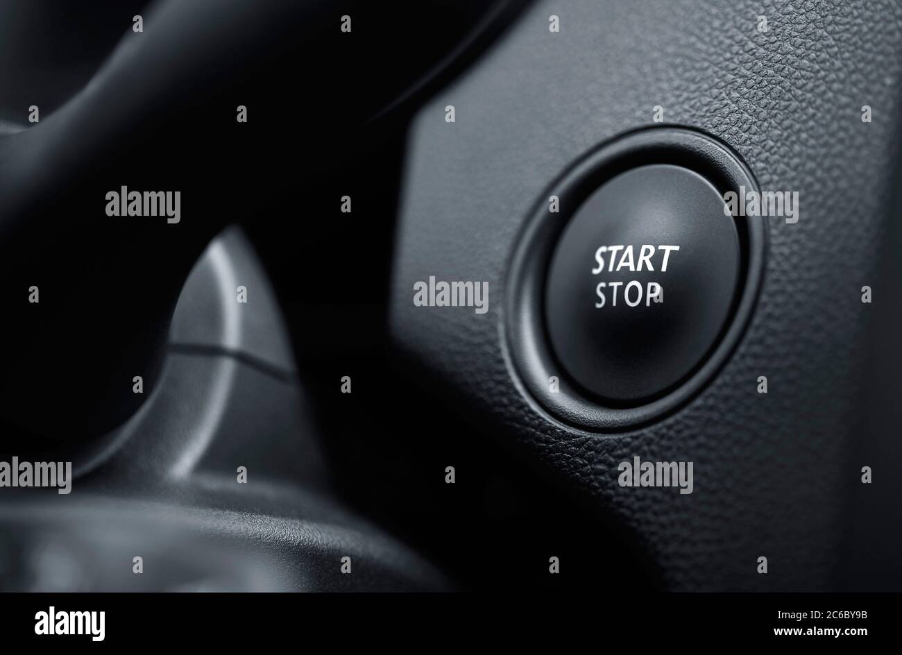 Start engine button. Start stop engine button on a modern car dashboard. Car engine start and stop button. Stock Photo