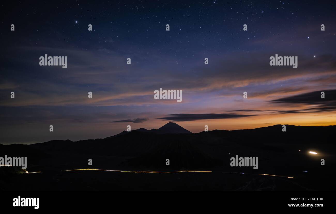 Stunning sunrise behind the silhouette of a mountain range that includes Mount Semeru, Mount Batok and Mount Bromo, Cemoro Lawang, Java, Indonesia Stock Photo