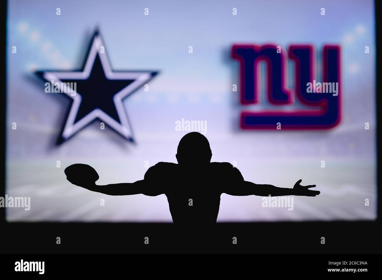 Dallas Cowboys vs. New York Giants. NFL Game. American Football League  match. Silhouette of professional player with open arms, who holds ball in  hand Stock Photo - Alamy